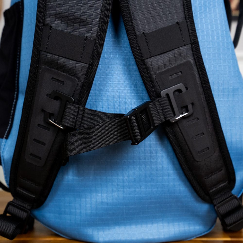 Close-up view of the back straps and buckle of the Cancha Tennis Travel Bundle, showcasing the attachment points and black padding, perfect for organizing your travel accessories.